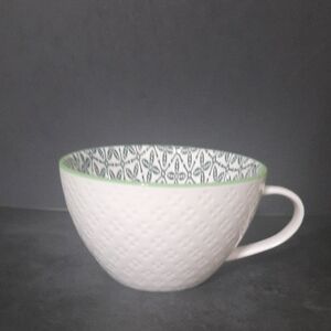 Textured White Ceramic Mug with Green Rim and Patterned Interior